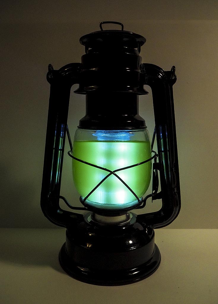 'A hurricane lantern gives off a green glow'