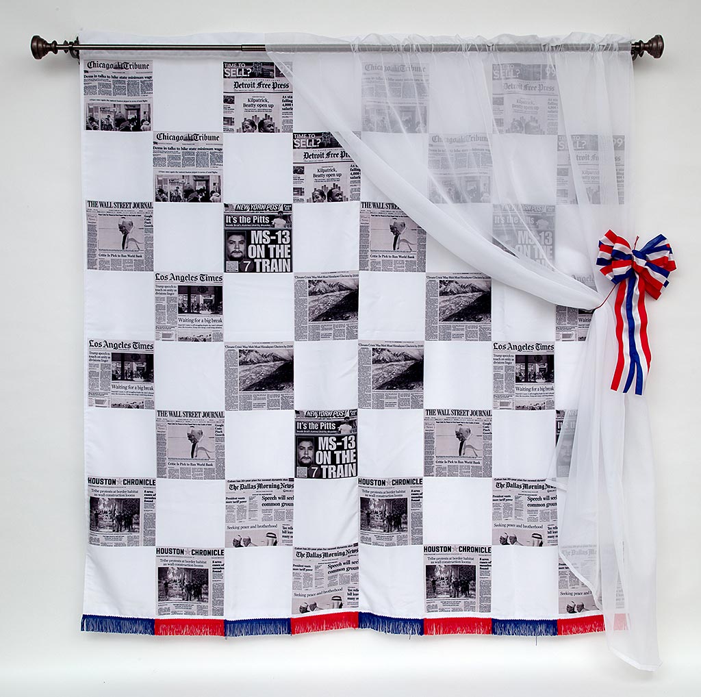 'A hanging tapestry with checkered boxes in white and black and white newspaper'