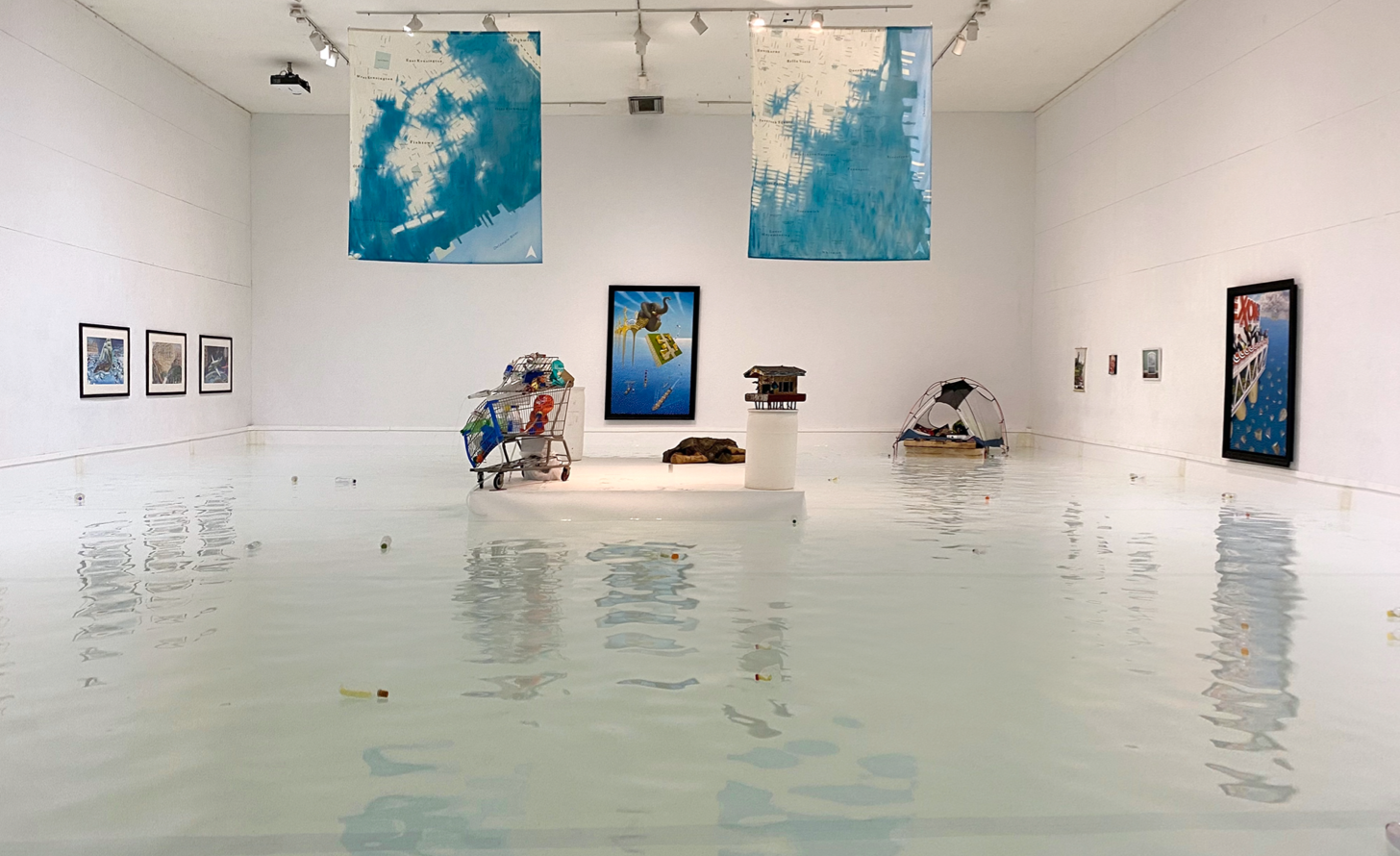 'The interior of the Icebox Project space, flooded with 6 inches of water on the floor, sculptures floating in the space, and paintings and other art hanging on the wall'